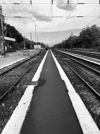 Empty railroad station platform against sky