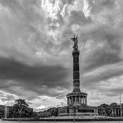 Low angle view of victory column against cloudy sky