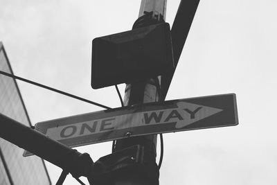 Low angle view of road sign against sky