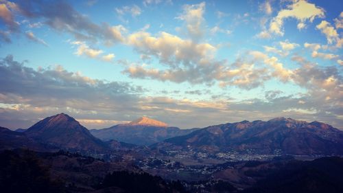 Scenic view of mountains against cloudy sky