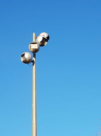 Low angle view of street light against clear blue sky