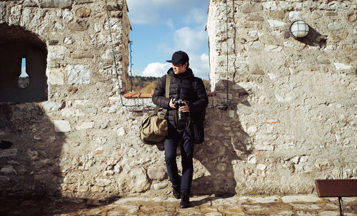 Full length of man standing against wall