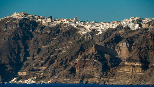 Panoramic view of sea and mountains against clear sky