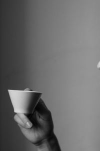 Close-up of hand holding coffee cup