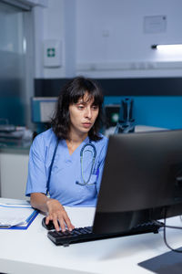 Nurse using computer in clinic