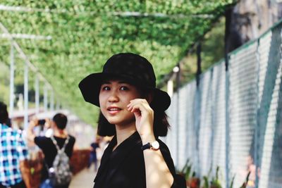 Portrait of young woman using mobile phone outdoors