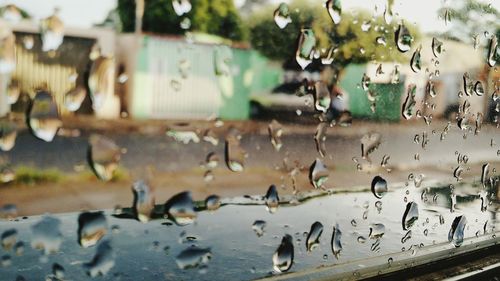 Street seen through wet glass window during monsoon