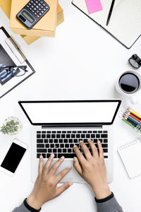 Low section of person using laptop on table