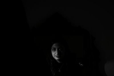 Portrait of beautiful young woman in darkroom
