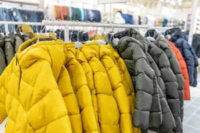 Row of clothes hanging on display at store