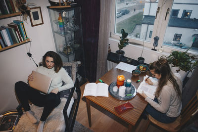 High angle view of young female students studying in college dorm room