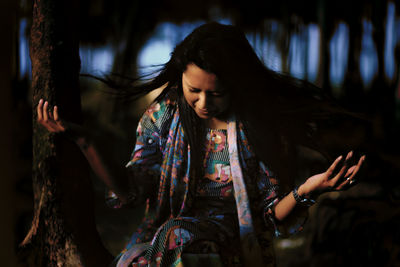 Young woman in forest at night