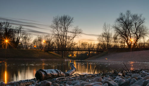 Bridge over river at sunset