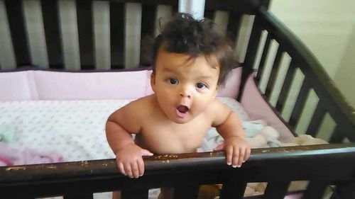 Portrait of cute girl sitting on railing
