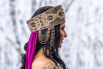 Close-up of young woman with headwear