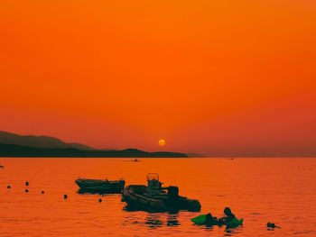 Scenic view of sea against orange sky