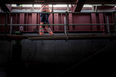 Rear view of man skateboarding on building