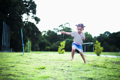 Full length of boy playing soccer on field