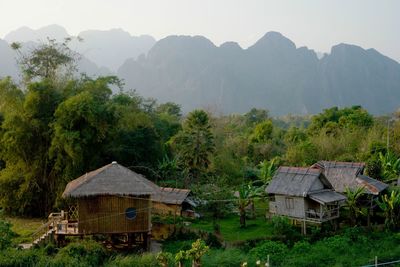 Thatched roof huts against mountains in village