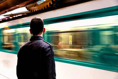 Rear view of man in underground station