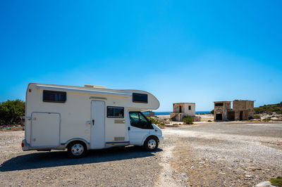 Low angle view of abandoned building against clear blue sky