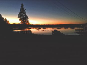 Scenic view of silhouette trees against sky at sunset