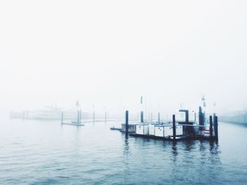 Harbor against sky during foggy weather