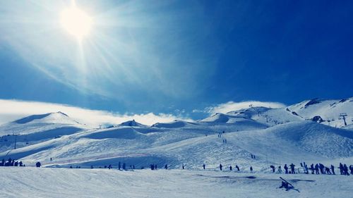 Tourists on snow covered mountain