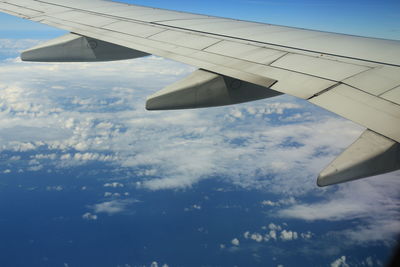 Aerial view of clouds over landscape seen from airplane