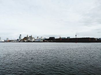 Scenic view of sea against sky in city