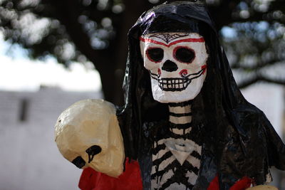 Close-up of spooky halloween decoration against tree