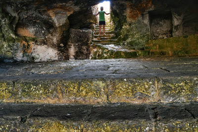 Water flowing through rocks against wall