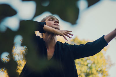 Woman looking away while standing outdoors