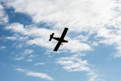 Low angle view of airplane against sky