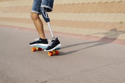 Disabled athlete skateboarding at sports court