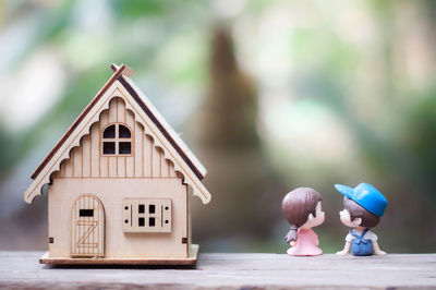 People holding toy in house against building