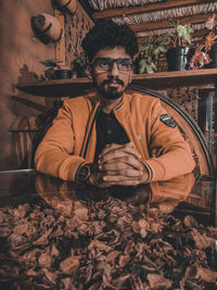 Portrait of young man sitting on floor