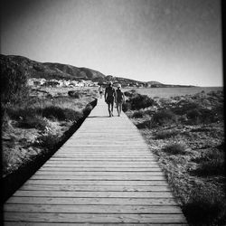 Rear view of man walking on beach