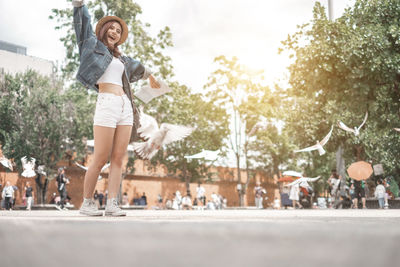 Portrait of smiling young woman in city