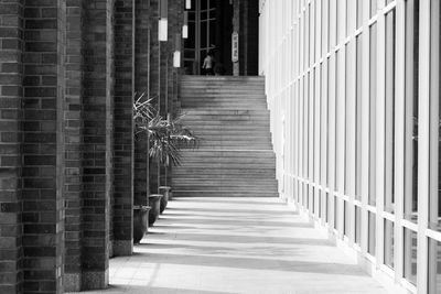 Corridor leading towards staircase in building