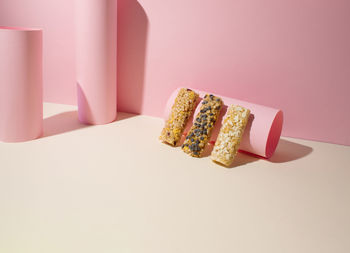 Energy bars on light pink and beige background. creative concept healthy food. copy space