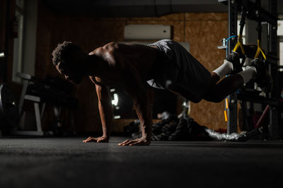 Full length of man exercising at gym