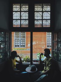 People sitting in glass window