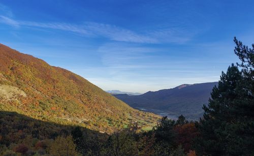 Scenic view of mountains against blue sky