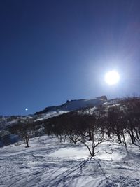 Scenic view of snow covered landscape against blue sky