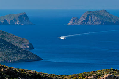 Scenic view of sea and mountains against sky