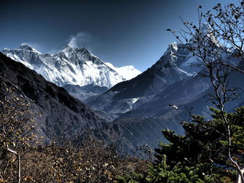 Scenic view of mountains against cloudy sky