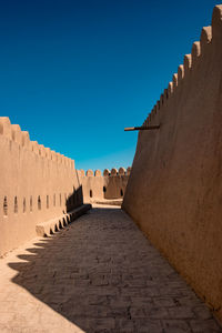 Low angle view of old ruins against clear blue sky