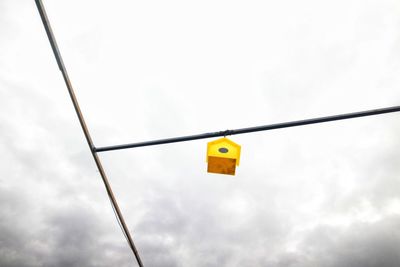 Low angle view of road sign against sky