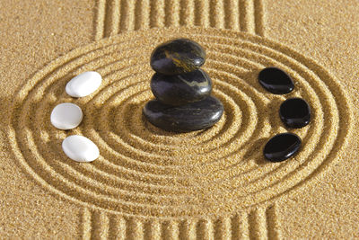 High angle view of pebbles on sand